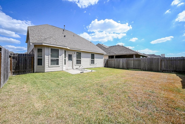 back of property with a patio area and a yard