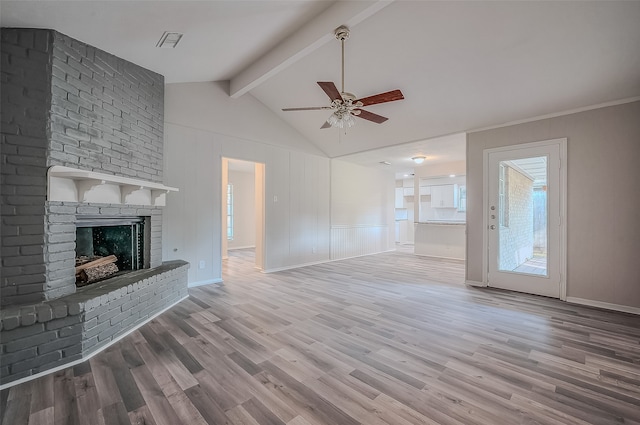 unfurnished living room featuring hardwood / wood-style floors, vaulted ceiling with beams, ceiling fan, and a brick fireplace