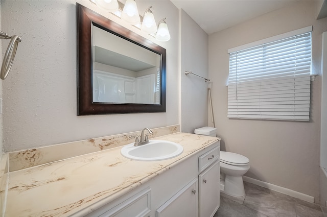 bathroom featuring tile patterned floors, vanity, and toilet