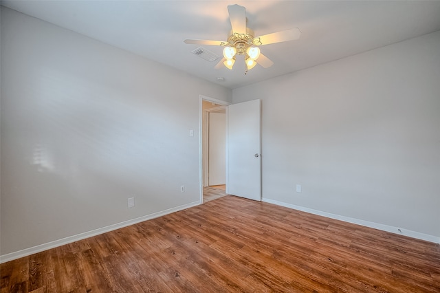 spare room with ceiling fan and hardwood / wood-style flooring