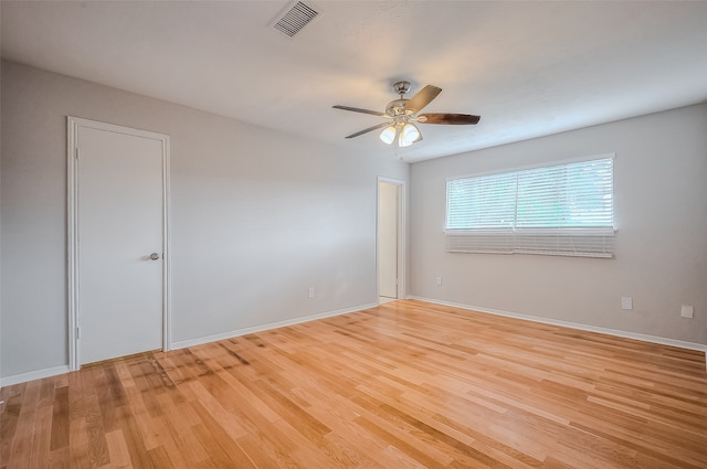 spare room featuring light hardwood / wood-style floors and ceiling fan