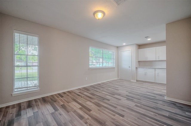 unfurnished living room with light hardwood / wood-style flooring