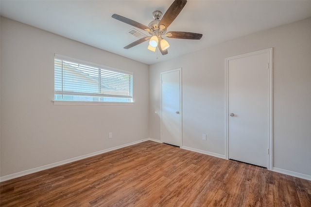 unfurnished bedroom featuring hardwood / wood-style floors and ceiling fan