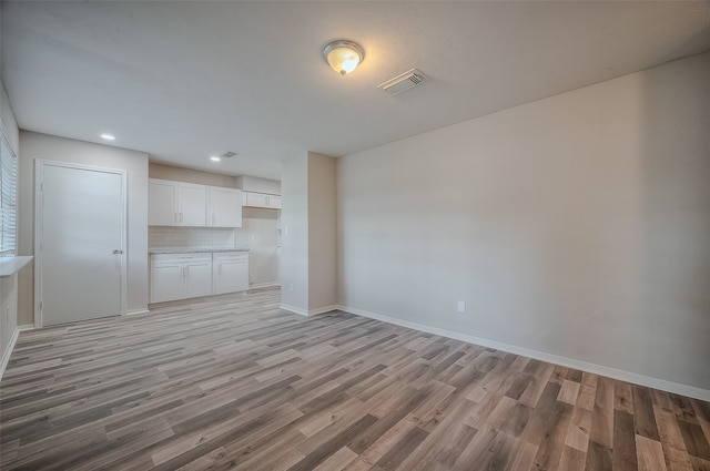 unfurnished living room with light hardwood / wood-style floors