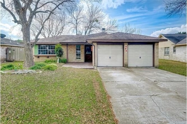 single story home with a garage and a front lawn