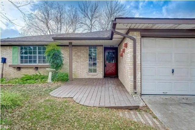 doorway to property with a deck and a garage