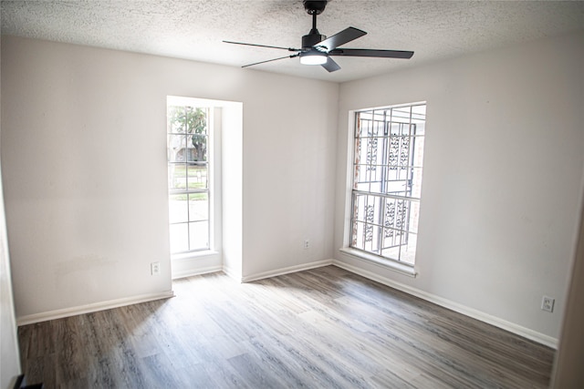 unfurnished room featuring a textured ceiling, hardwood / wood-style floors, a healthy amount of sunlight, and ceiling fan