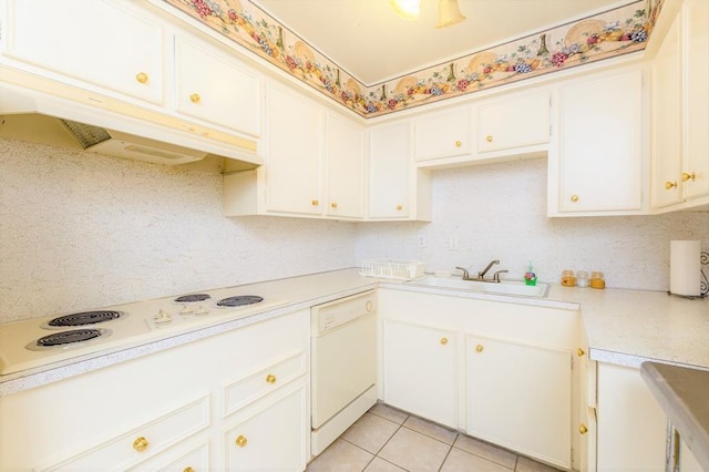 kitchen featuring white cabinets, light tile patterned floors, white appliances, and sink