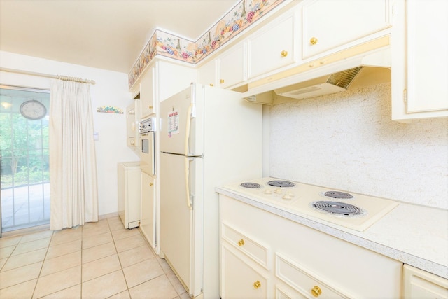 kitchen featuring white cabinets, light tile patterned flooring, and white appliances