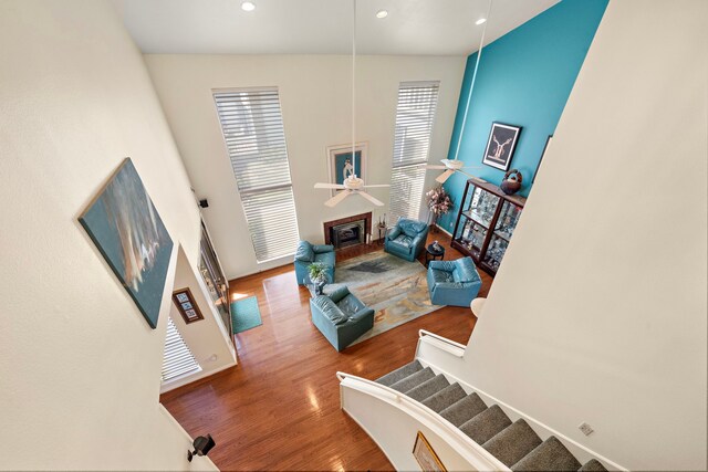 living room with hardwood / wood-style flooring and ceiling fan