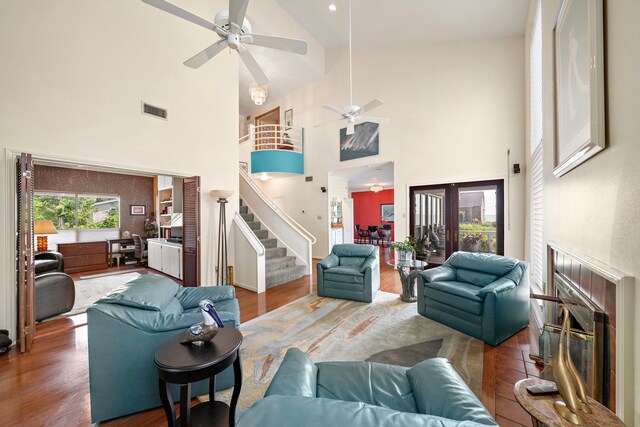 living room with high vaulted ceiling and dark wood-type flooring