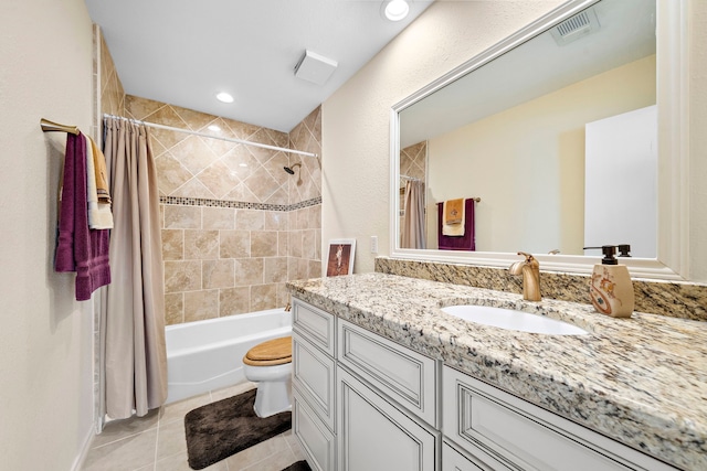 full bathroom featuring shower / bath combo with shower curtain, tile patterned flooring, vanity, and toilet