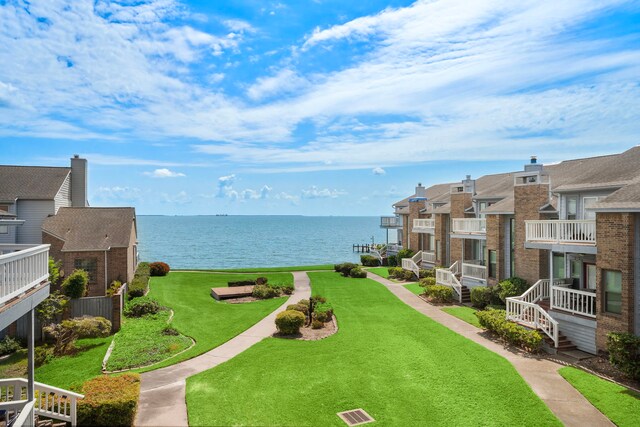 view of home's community featuring a yard and a water view