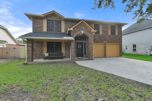 view of front of home featuring a garage, a front yard, and a porch