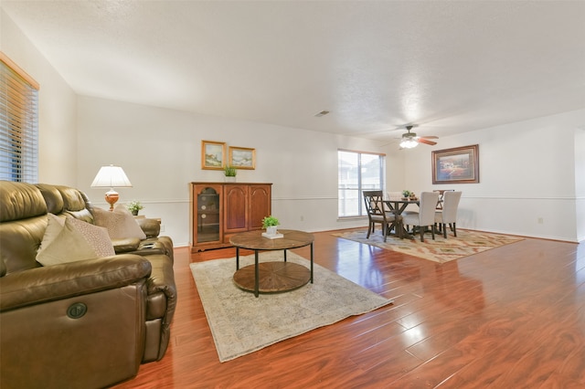 living room featuring ceiling fan and wood-type flooring