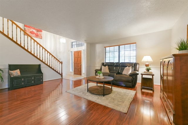 living room with hardwood / wood-style flooring and a textured ceiling