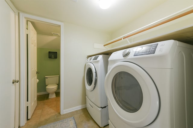 laundry area featuring light tile patterned flooring and independent washer and dryer