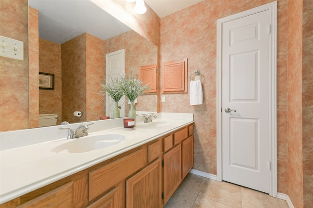 bathroom with vanity, tile patterned floors, and toilet