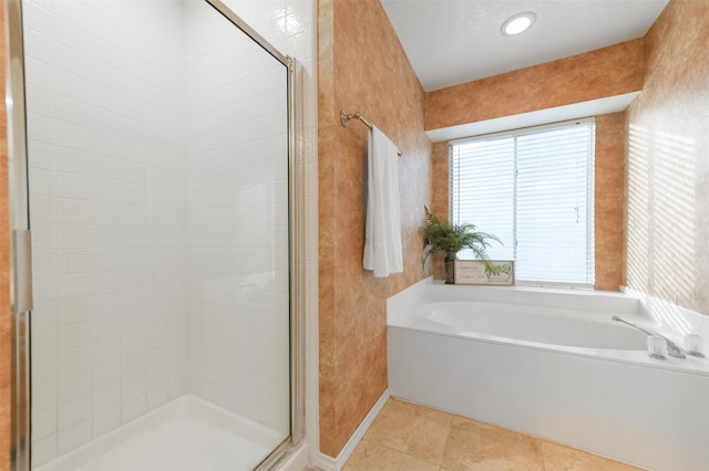 bathroom featuring tile patterned flooring, shower with separate bathtub, and a textured ceiling