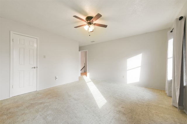 carpeted empty room with ceiling fan