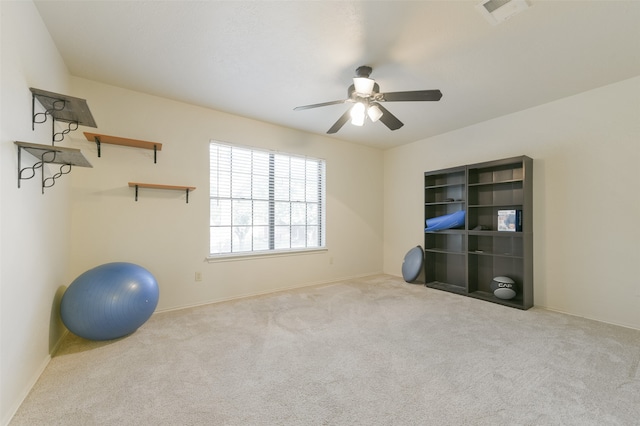 workout area featuring light carpet and ceiling fan