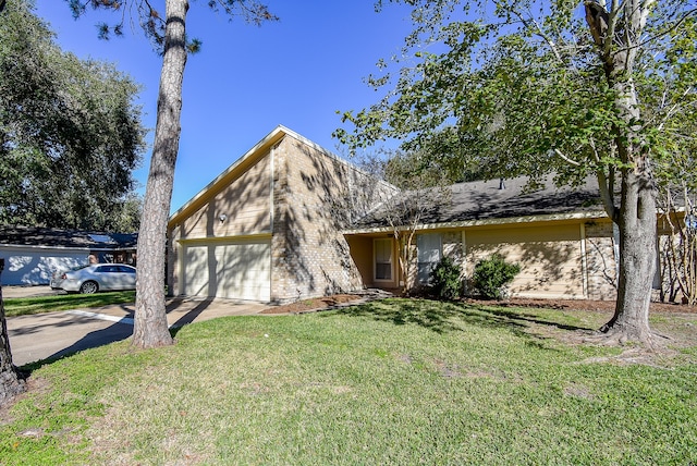 view of front of house featuring a garage and a front lawn