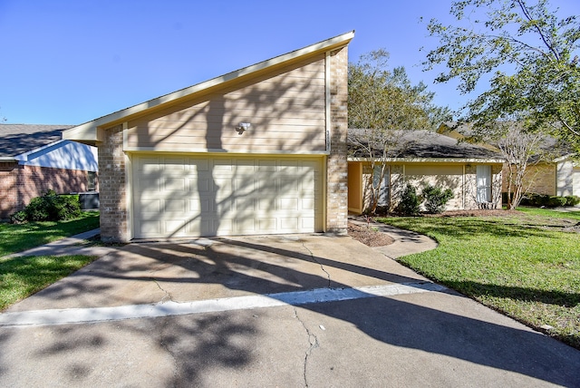 view of front of property with a garage and a front lawn