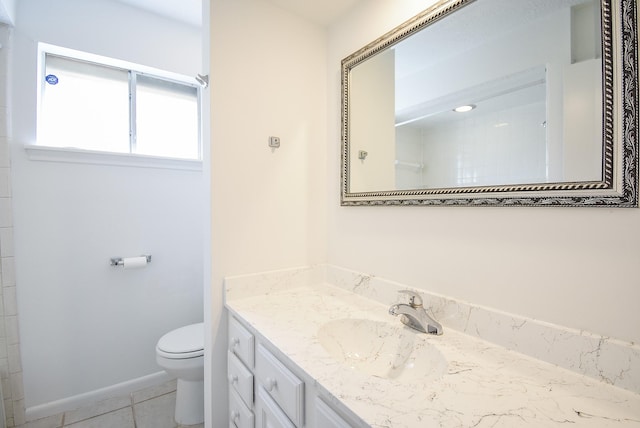 bathroom featuring tile patterned flooring, vanity, and toilet