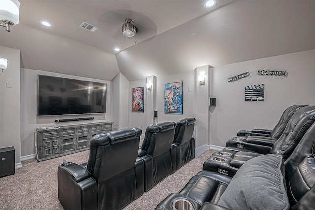 carpeted cinema room with ceiling fan and vaulted ceiling