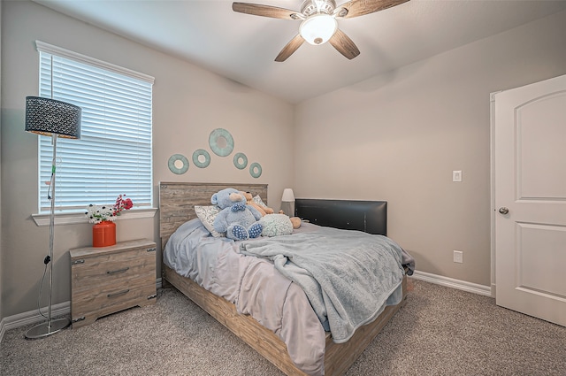 bedroom with light colored carpet, multiple windows, and ceiling fan