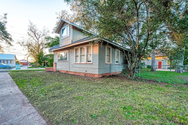 view of property exterior with a lawn