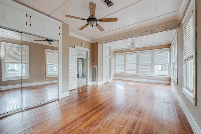 interior space with ceiling fan, crown molding, and light wood-type flooring