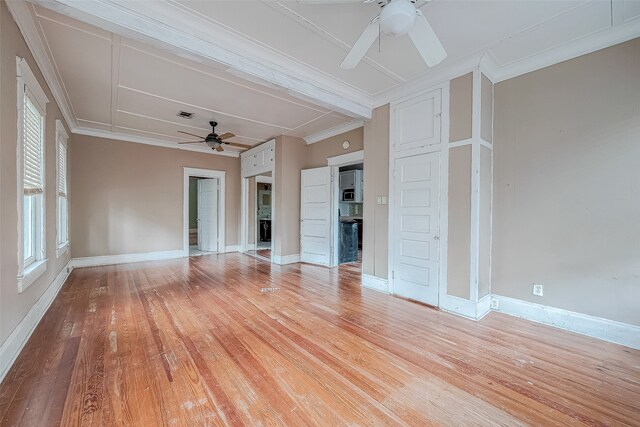 unfurnished living room featuring ceiling fan, ornamental molding, and light wood-type flooring