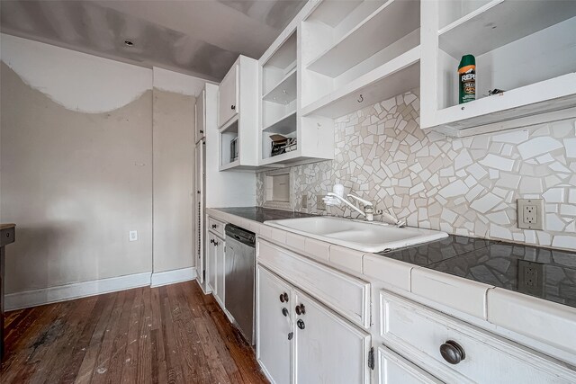 kitchen with sink, tasteful backsplash, dark hardwood / wood-style flooring, stainless steel dishwasher, and white cabinets