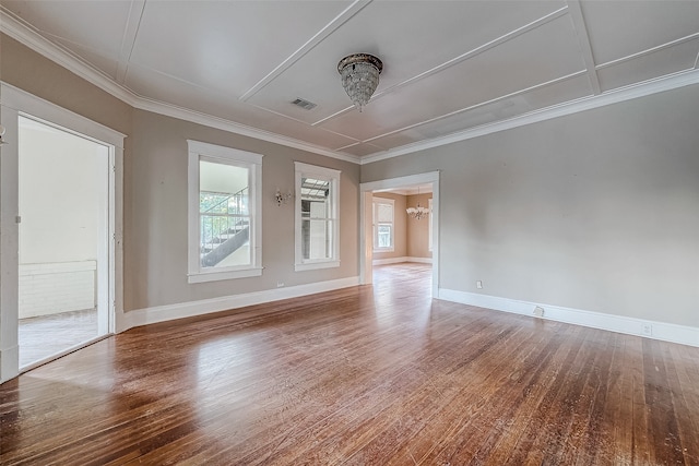 unfurnished room with hardwood / wood-style flooring, crown molding, and a chandelier