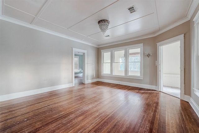 empty room featuring ornamental molding and hardwood / wood-style flooring