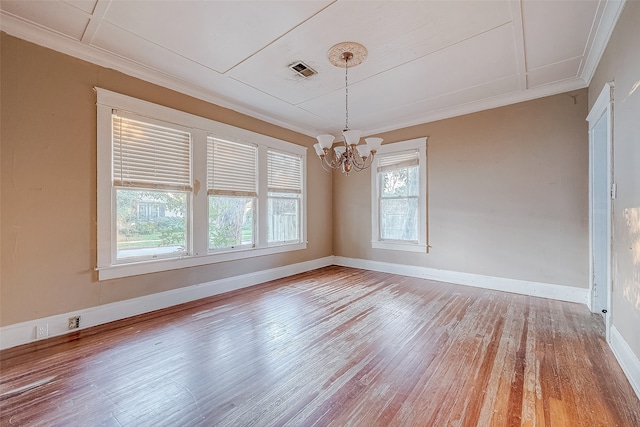 unfurnished dining area featuring a chandelier, ornamental molding, hardwood / wood-style flooring, and a healthy amount of sunlight