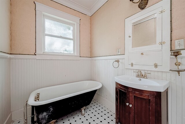 bathroom with vanity, a bath, and crown molding