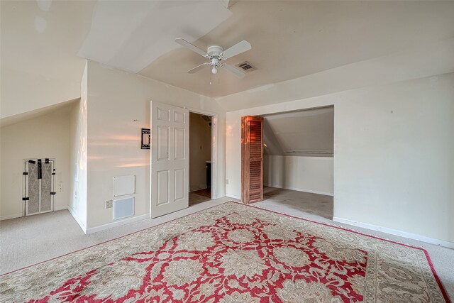 bedroom with carpet flooring, ceiling fan, a closet, and lofted ceiling