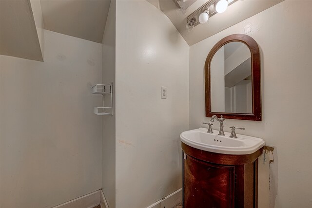 bathroom featuring vanity and vaulted ceiling