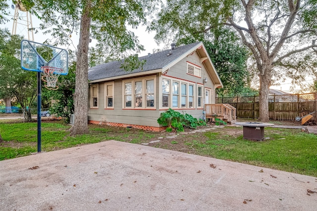 back of property with a patio area and a yard