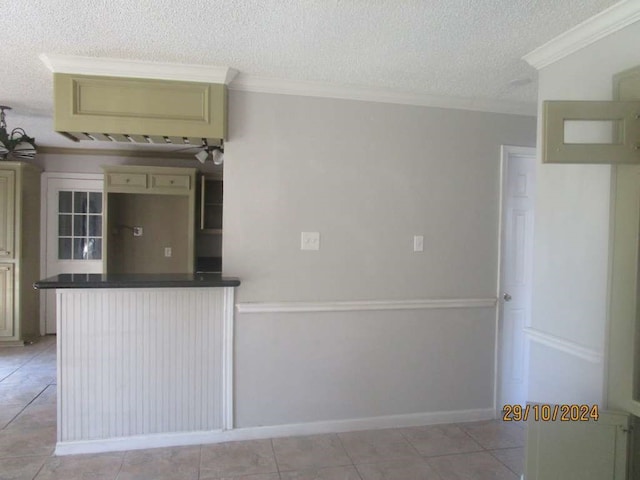 kitchen with a textured ceiling, light tile patterned floors, and crown molding