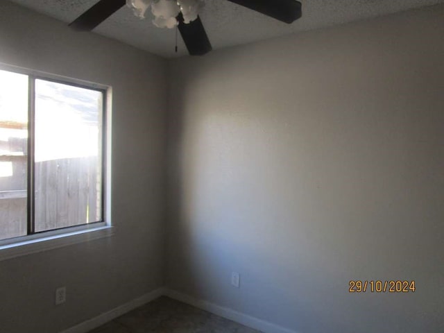 unfurnished room with plenty of natural light and ceiling fan