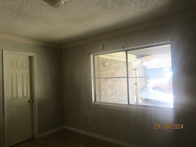 unfurnished room featuring a textured ceiling and ornamental molding