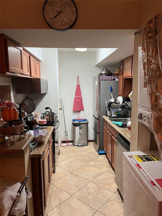 kitchen with sink, light tile patterned floors, stainless steel appliances, and extractor fan