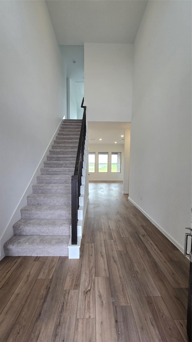 stairs featuring wood-type flooring