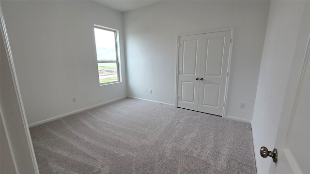 empty room featuring light colored carpet