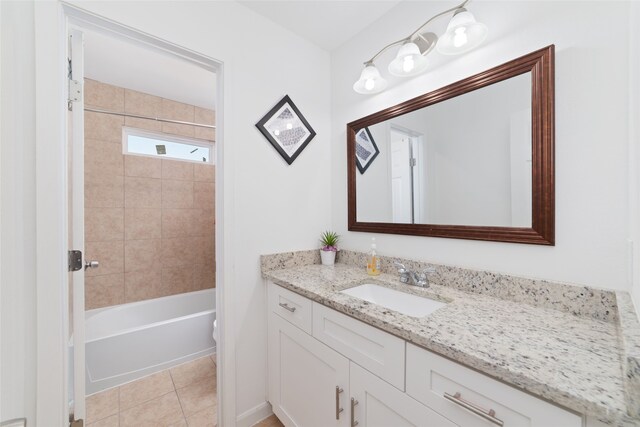 full bathroom with toilet, tiled shower / bath combo, vanity, and tile patterned flooring