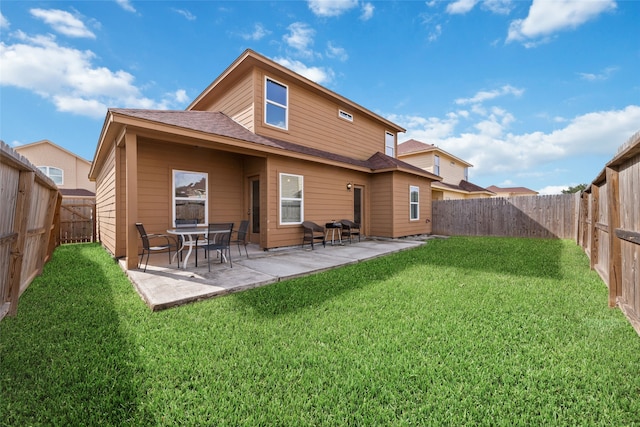 rear view of property with a patio area and a lawn