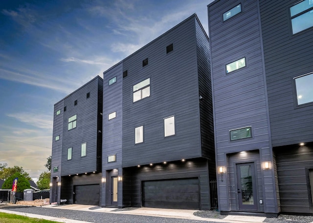 property exterior at dusk with a garage